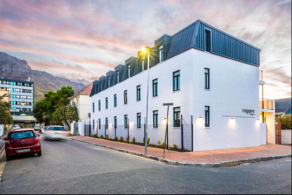 Copper, a three-storey white residential building on Cavendish Street, Woodstock, at dusk